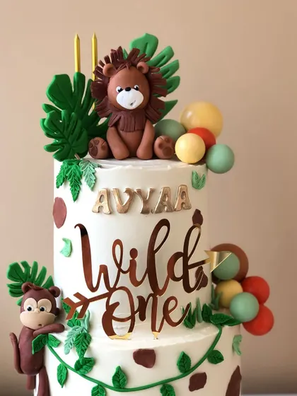 A close-up of the "Wild One" cake topper and the adorable lion figure.