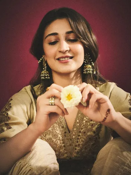 A sweet and happy shot that showcases the joy of dressing up. The flower adds a touch of natural beauty to the look.