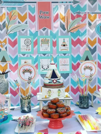A closer look at the Aztec-themed dessert table, featuring a teepee-shaped cake and treats that match the colorful, wild-and-free party decor.