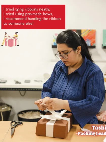 Our Packing Lead, Tashi, recommends handing the ribbon to someone else. A funny and relatable take on the challenges of getting that perfect bow.