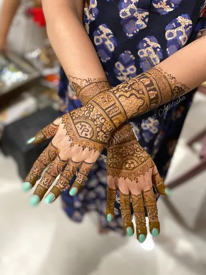 An elegant engagement mehendi with personalized initials. The design is dense and intricate, perfect for celebrating a special commitment.