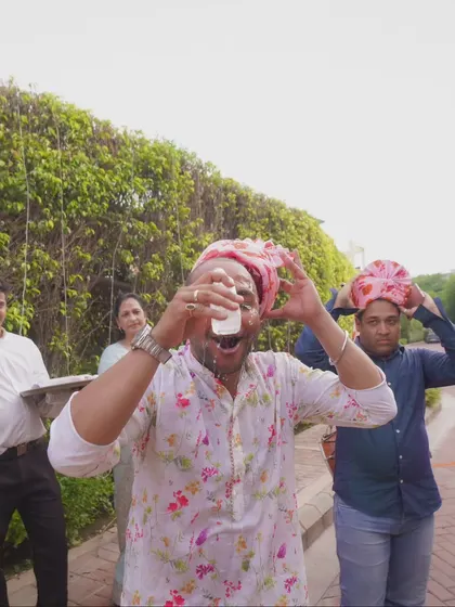 A guest enjoying a welcome drink during the baraat. It's the small details and candid moments that capture the full experience of the day.