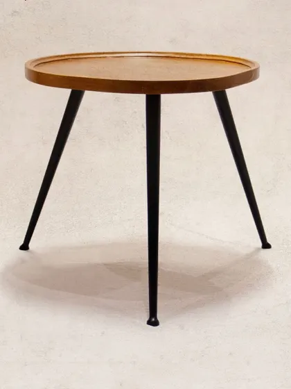 Another view of the 'Tipoy' side table, showcasing its clean design. The raised edge of the teak top is a practical detail to keep items secure.