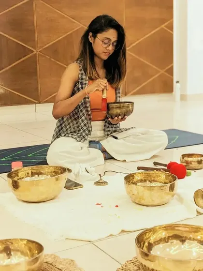 A focused shot of me playing a singing bowl, highlighting the care and intention I put into every sound I create.