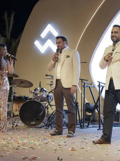 Interacting with the leadership of WAL Developments on stage. As a host, I facilitate key moments, ensuring that the company's leaders can connect with their partners and employees in a celebratory setting.