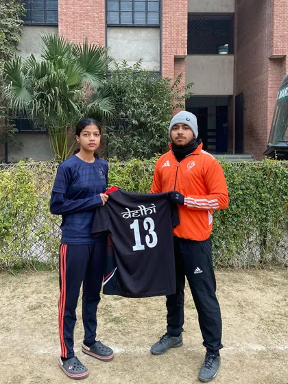 Sampada, another one of our talented players, holding her Delhi U19 jersey. We are proud to coach and develop players for every age category.
