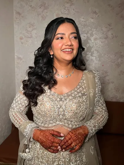 A candid moment of laughter. The makeup is designed to look natural and flawless, even in spontaneous shots.
