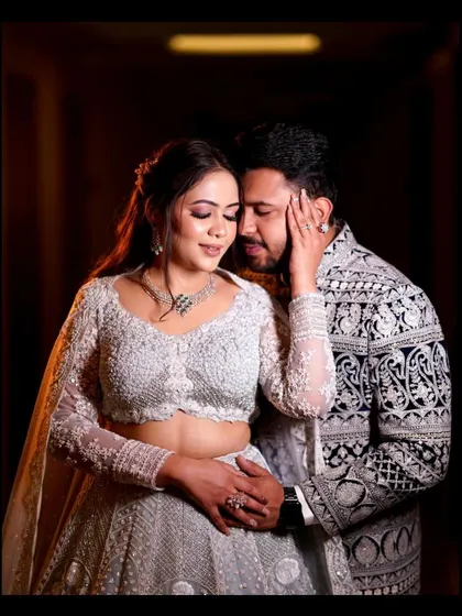 An intimate and tender portrait from an engagement party. The bride's gentle touch and the couple's close embrace create a feeling of warmth and deep connection.