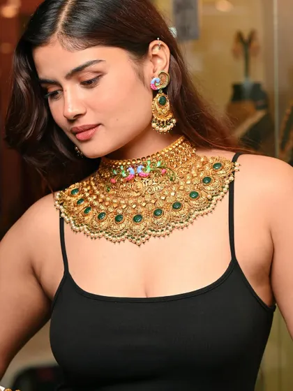 A detailed shot of a stunning peacock-themed bridal necklace. For jewellery photography, it's crucial to capture the craftsmanship and vibrant colors of each piece.