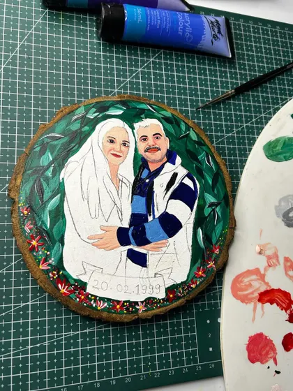 Another progress shot of the custom couple illustration, showing the addition of color and details to the portrait.