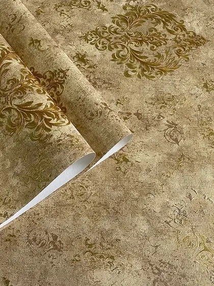 A close-up of a brown wallpaper roll with a distressed texture and a subtle damask pattern.