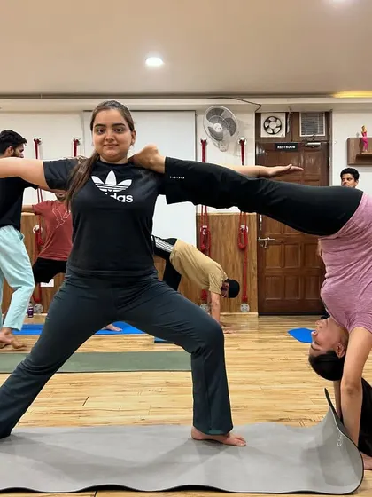 This partner pose showcases incredible trust and core strength. It's a beautiful example of how we can support each other to create amazing shapes.