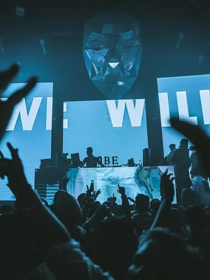 The crowd with their hands up at MOBE. The visuals on the screen behind me are part of the story I'm telling through my audio-visual set.