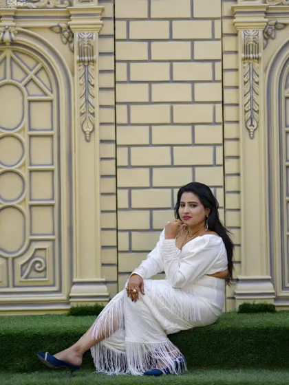 A chic and modern portrait taken outdoors against a stylish architectural wall.