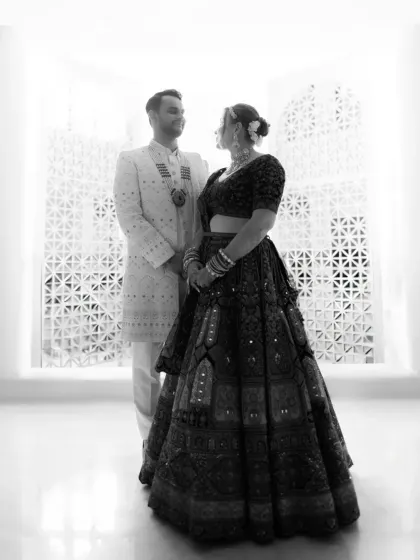 A classic black and white portrait of the couple against a beautifully patterned wall, highlighting their silhouettes and connection.