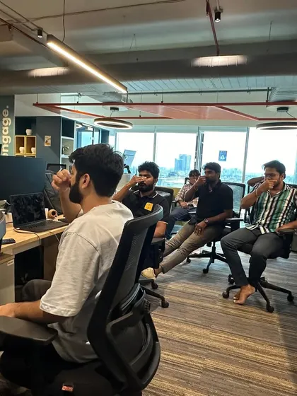 Employees practicing Anulom Vilom (alternate nostril breathing) at their desks to calm the nervous system and enhance focus.