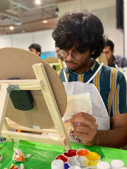 A participant at the LinkedIn clock painting workshop, deep in concentration. It's a great way to practice focus and creativity in a low-pressure environment.