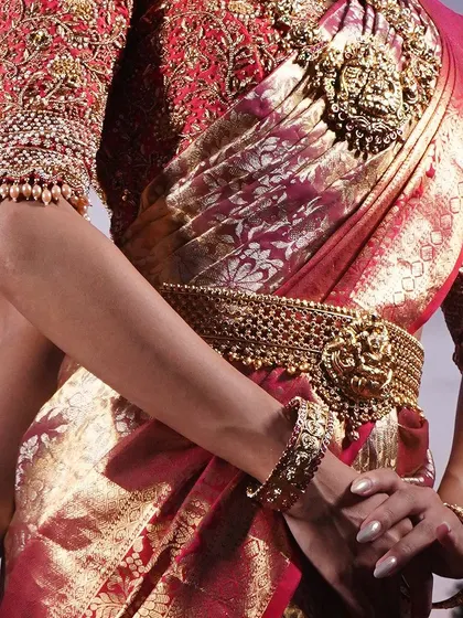 Details matter, right down to the sleeve cuffs. This close-up shows the edge of a heavily embroidered sleeve, finished with a delicate line of small pearls that add a final touch of elegance.