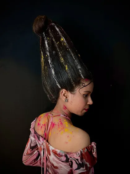 An example of abstract hairstyling, where hair is sculpted into a tall, artistic shape and accented with paint. This showcases the limitless creativity we encourage in our advanced workshops.