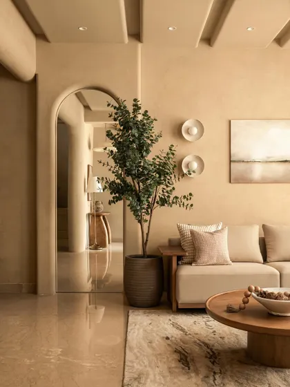Another view showcasing the interplay of arches and natural elements. The tall plant acts as a verdant focal point against the honey-toned, textured walls, creating a room that truly breathes.