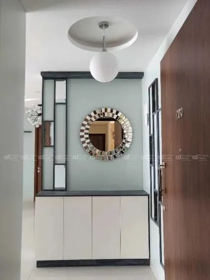 A clear shot of the foyer setup, with its blend of modern furniture and decorative elements that reflect the home's unique style.