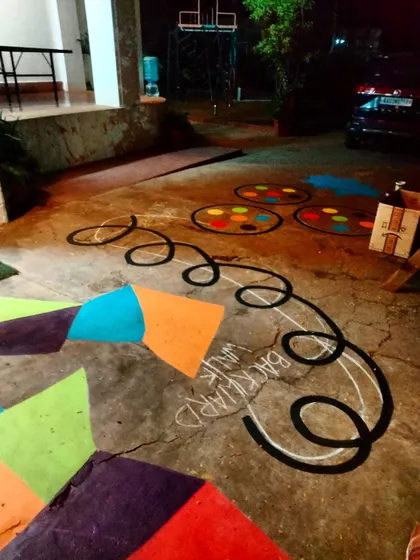 A section of the floor mural featuring a "Backward Walk" loop and a colorful version of Twister. This is art that you can physically engage with.