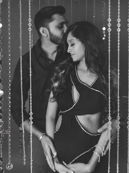 A tender moment between partners, captured in timeless black and white. This style emphasizes the emotion and connection, creating a truly romantic maternity portrait.