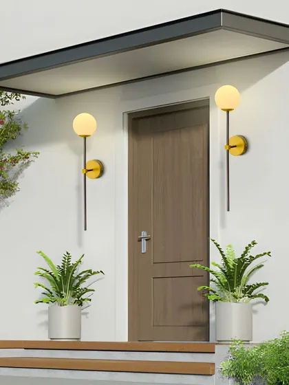 The globe wall sconces used to frame an entryway, creating a warm and welcoming entrance.