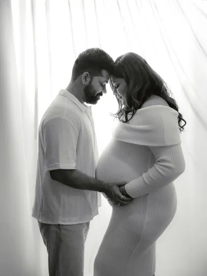 A simple, tender moment. This black and white portrait captures the quiet connection between the couple, with soft backlighting creating an intimate and gentle mood.