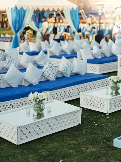 Comfortable and stylish low seating arrangements for a relaxed Mehendi Sangeet. The blue and white block print cushions add a traditional touch to the modern setup.