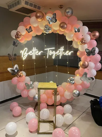 Celebrate your love story with our "Better Together" ring setup. This romantic design uses a soft palette of pink, white, and rose gold balloons, accented with delicate butterfly details and a custom neon sign, making it ideal for anniversaries or engagement parties.