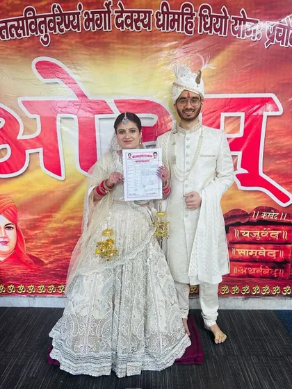 Dressed in their wedding best, this couple holds their court marriage registration certificate. I am here to help you navigate the legalities of your union.