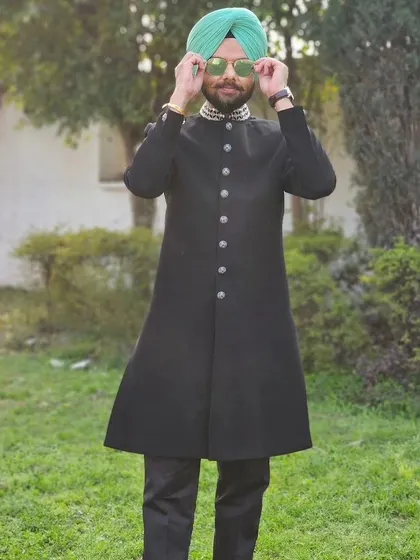 Comedian Jaspreet Singh looking sharp in our black asymmetric Indo-western sherwani with an embellished collar. Style and humor are a great combination.