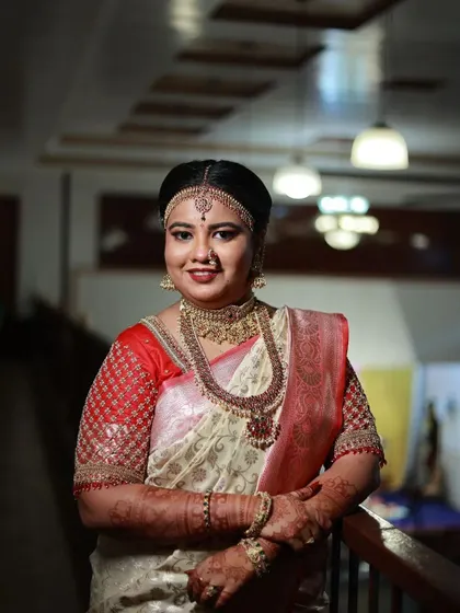 A frontal view of the bride, showcasing the full glory of the layered necklaces and the intricate work on the choker.