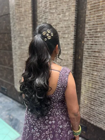 For receptions and modern events, a stylish high ponytail with soft waves is a great choice. It's chic, comfortable, and keeps the hair off your face while you celebrate.