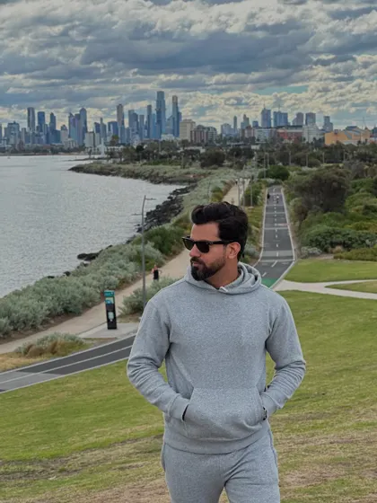 The grey tracksuit shown in a wider shot, perfectly blending urban style with outdoor leisure.