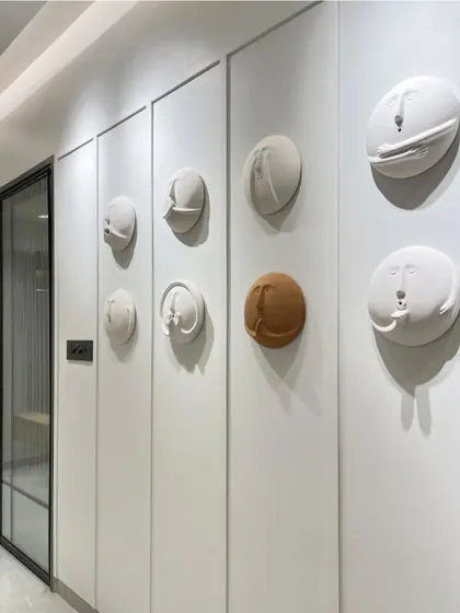 Another shot of the unique clay face wall art.