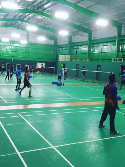 Multiple games underway during a company team outing in Bangalore. The spaciousness of the hall prevents overcrowding and allows for comfortable play across all courts.