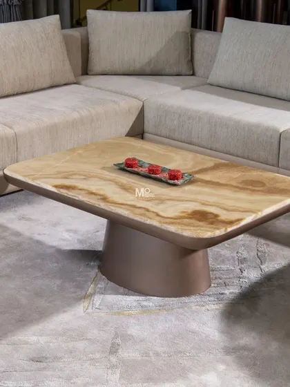 The Wellen Coffee Table, a harmonious blend of natural onyx and modern design. The wavy texture of the stone top captures the fluidity of water, while the warm brown pedestal base provides a simple, symmetrical foundation.