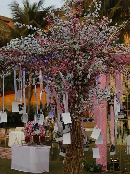 A memory tree adorned with the couple's photos and notes from guests. This is a beautiful and personal decor element that tells the couple's story and involves the guests in their journey.