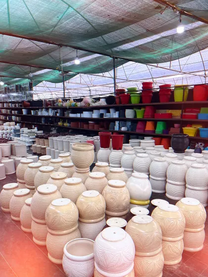 Another look at our extensive range of planters. You can see the variety of shapes, sizes, and colors we offer, from classic terracotta styles to modern plastic ones.