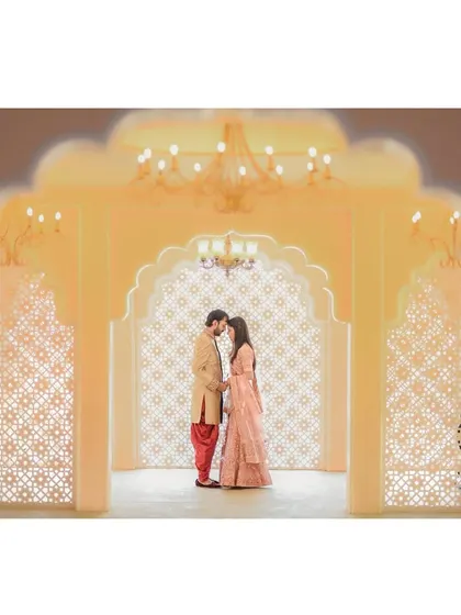 A stunning wide shot of the couple in a grand, palace-like setting. This type of environmental portrait creates a sense of fairytale romance.