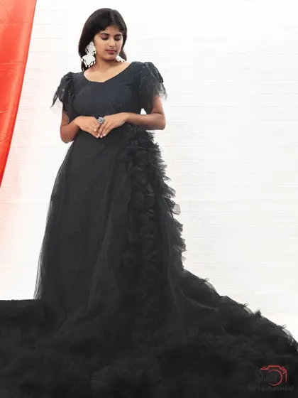 A full view of our black ruffle gown with a long trail, a stunning piece from our collection in BTM Layout.