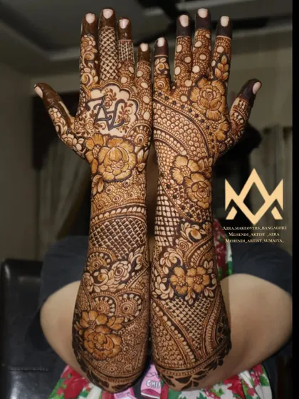 A full view of a bridal mehendi with personalized initials on the palm.