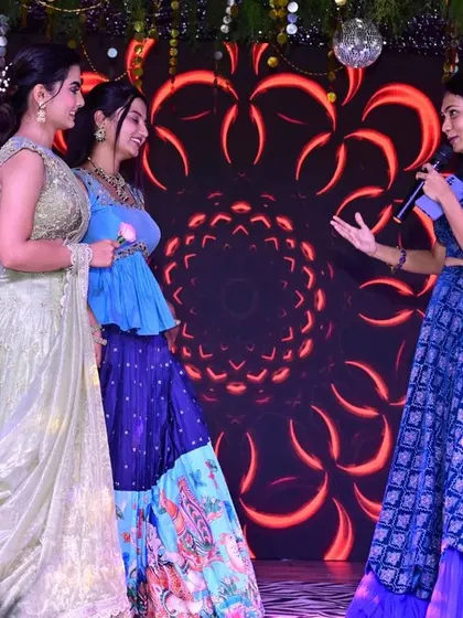 Hosting a Sangeeth event in style. This client is wearing a royal blue crop top and skirt set, a comfortable and elegant choice for an event host.