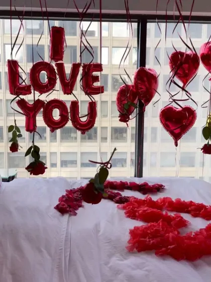 A close-up look at the details, including the 'I LOVE YOU' foil balloons and individual roses attached to hanging ribbons. Every element is placed with care to create the perfect romantic mood.