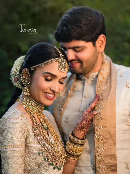 A tender moment between the couple. The bride's dewy skin and happy smile are the highlights of this beautiful, natural-light portrait.
