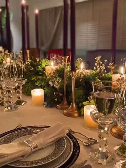 An elegant and intimate dinner setting with crystal glassware and tall candles. I work to create a sophisticated dining experience, whether the event is large or small.