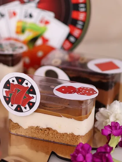 A close up of the Lotus Biscoff Cheesecake tub from our Diwali platter, decorated with a lucky number 7 chip.