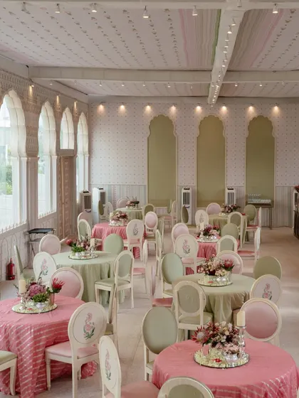 The elegant hi-tea setup, with pastel-colored linens and floral centerpieces, creating a welcoming space for guests.